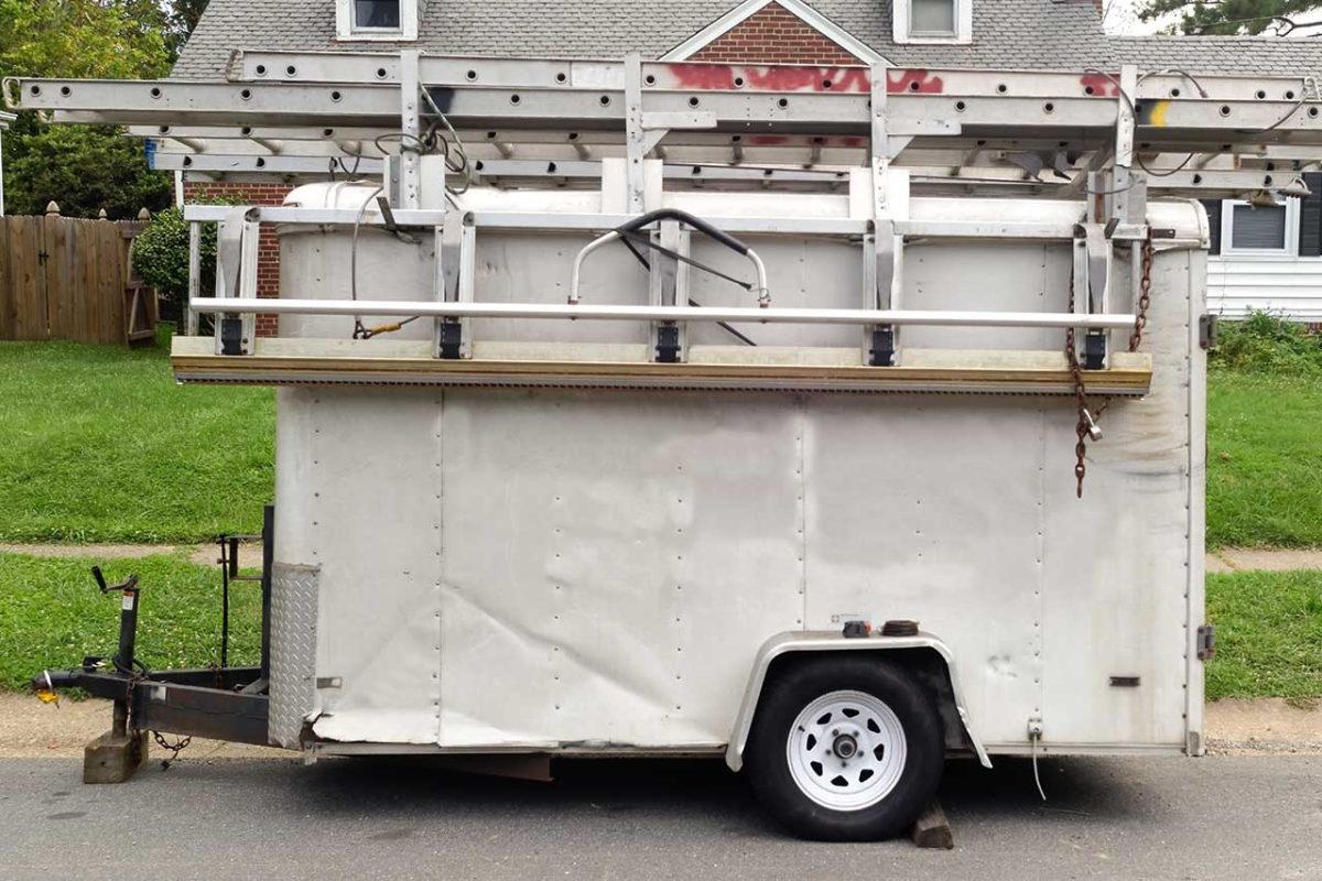 White utility trailer with ladders